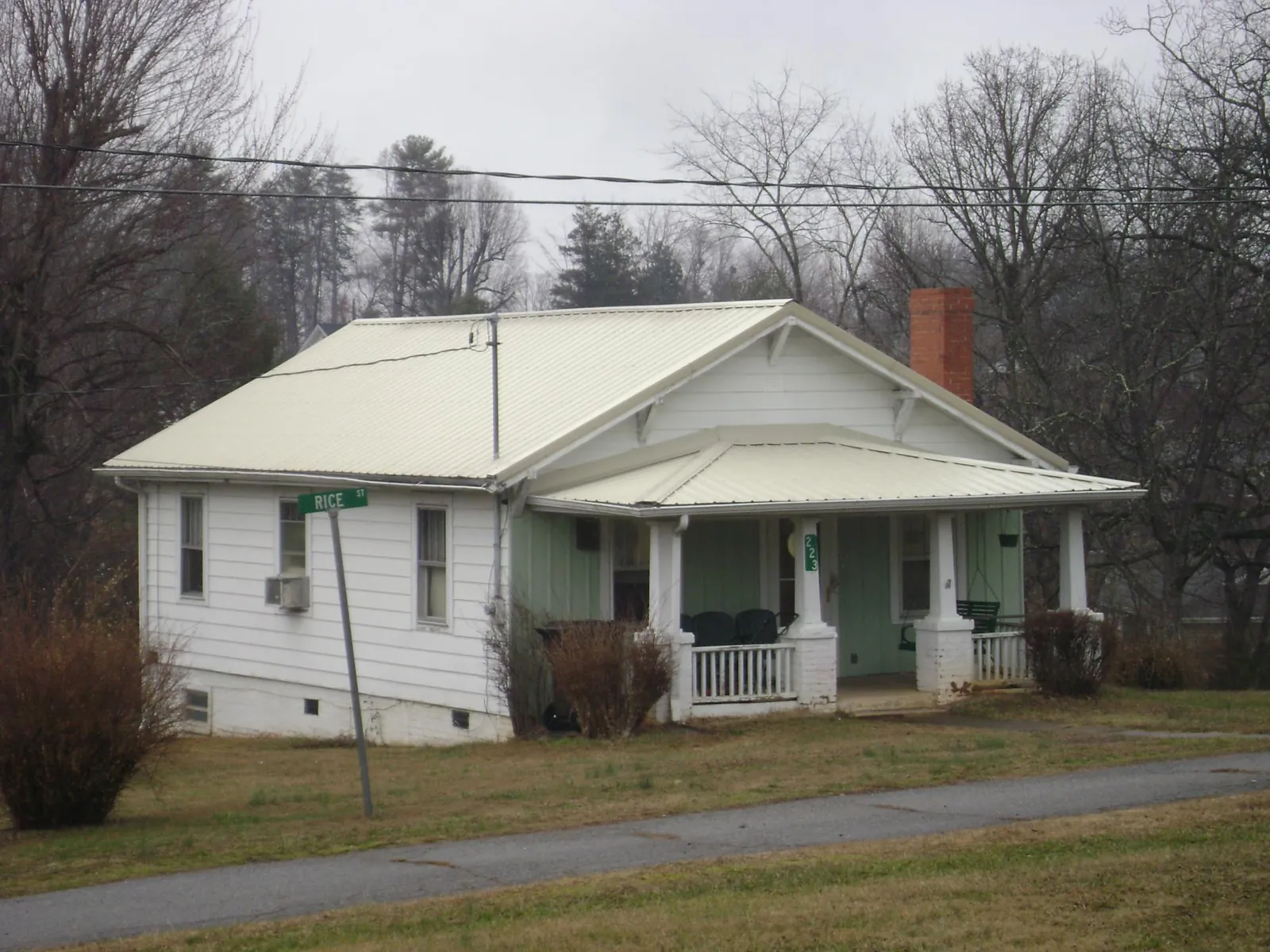 White metal roof on a craftsman bungalow at a street corner in Porter